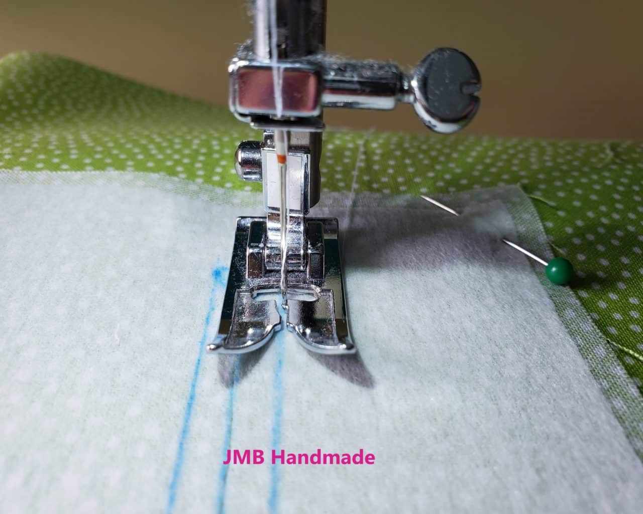 Sewing machine zipper foot used to sew outline of zippered pocket opening