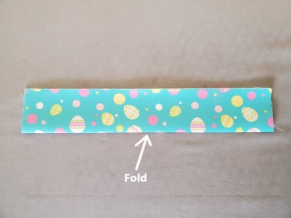 Fold fabric Easter basket strap in half lengthwise