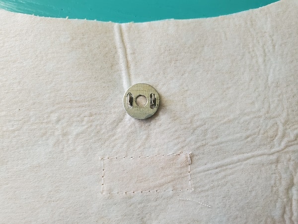 Place washer through slots on back of male snap piece