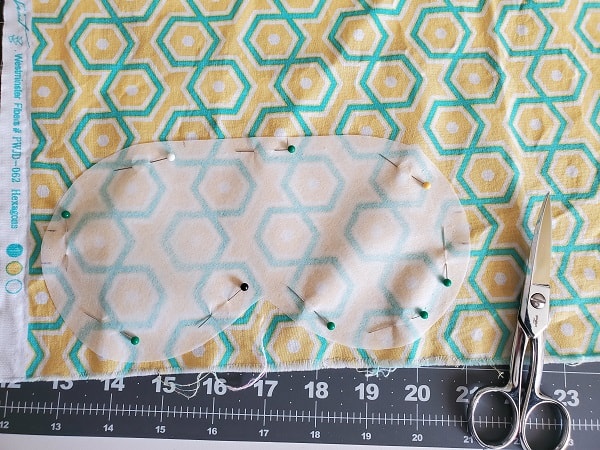 Pin template to sleep mask lining fabric and cut out