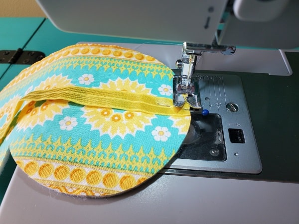 Baste elastic to sleep mask front piece with sewing machine