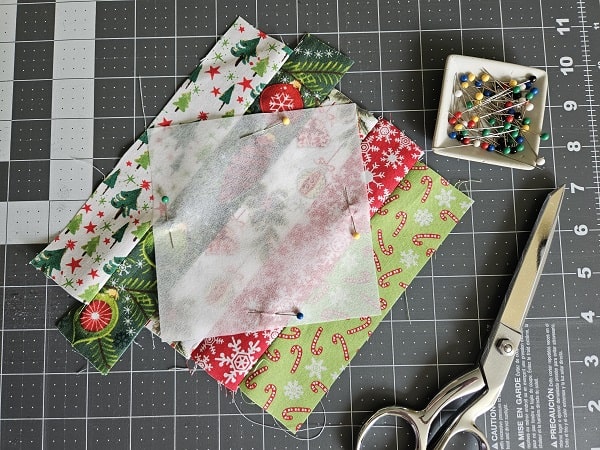Square coaster template pinned to fabric