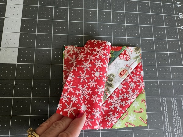 Square coaster on top of fabric strips right sides together