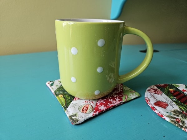 Mug on top of quilted fabric square coaster