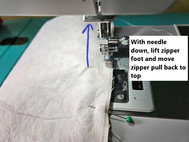With needle down, lift zipper foot and move zipper pull back to top