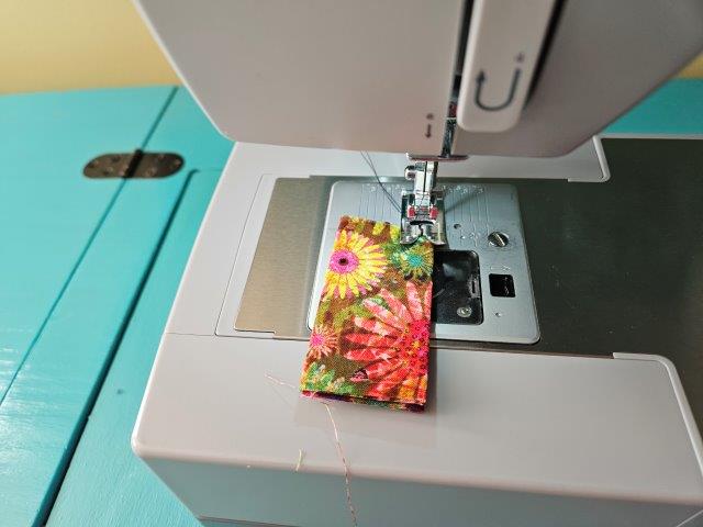 Sew folded edges of short straps