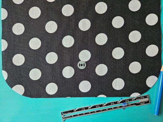 Place magnetic snap washer on flap lining fabric piece