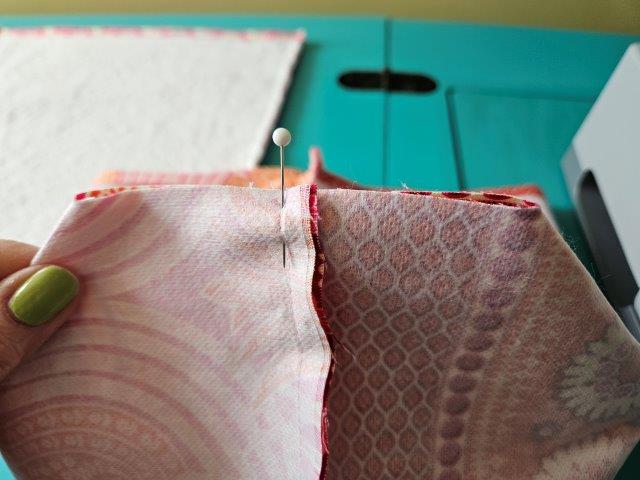 Line up the seams of the fabric bottom and pin