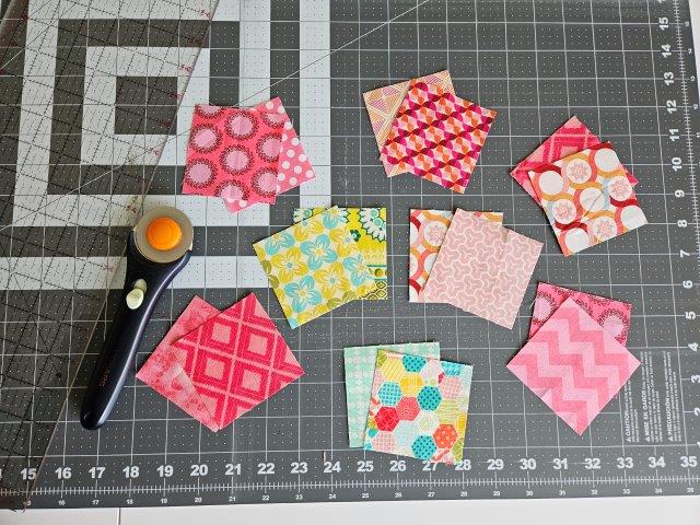 Cut fabric squares out of fabric scraps