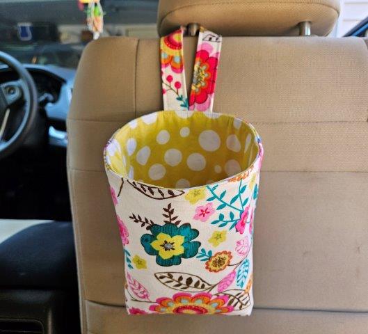 Finished car trash bag hanging from headrest