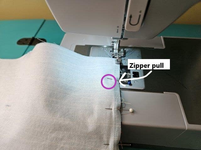 Begin to sew the zipper on the makeup bag