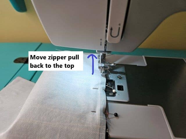 Move the zipper pull to the top and continue sewing