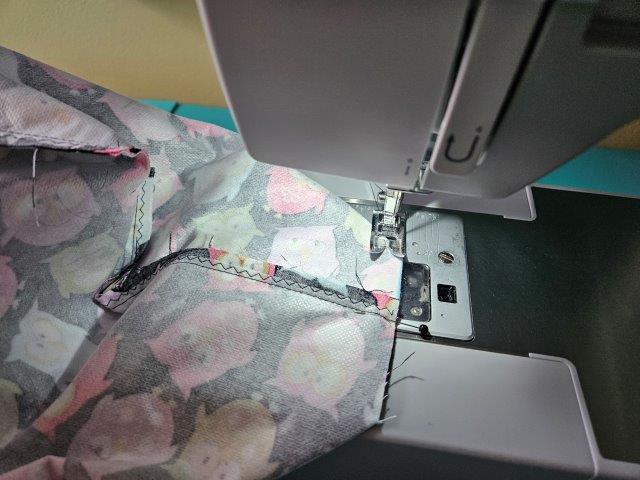 Sew along the edge to square the bottom of the makeup bag.