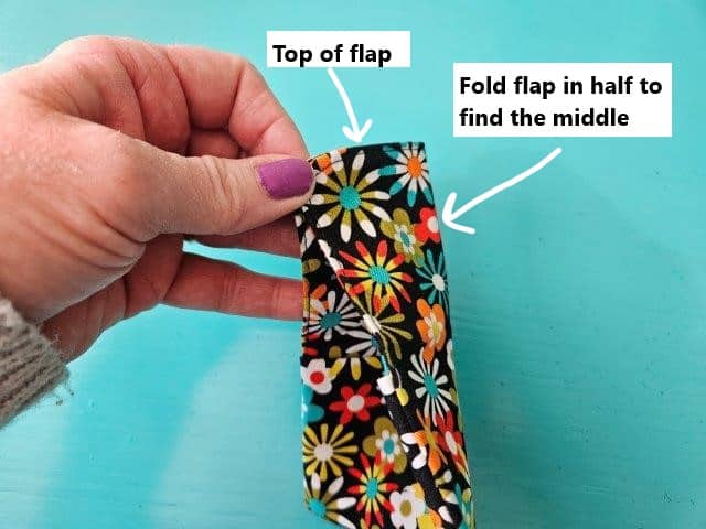 Fold the flap in half to find the middle