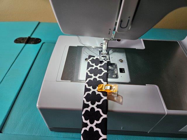 Sew the straps along each folded edge