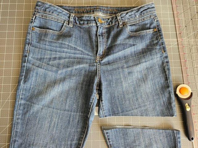 Cut one of the legs of the jeans