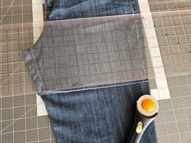 Fold the jeans in half