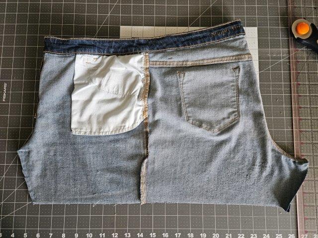 Turn the jeans inside out and fold in half