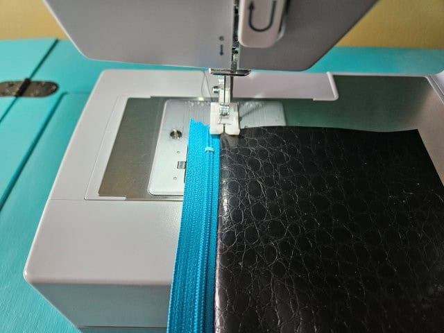 Top stitch along the zipper