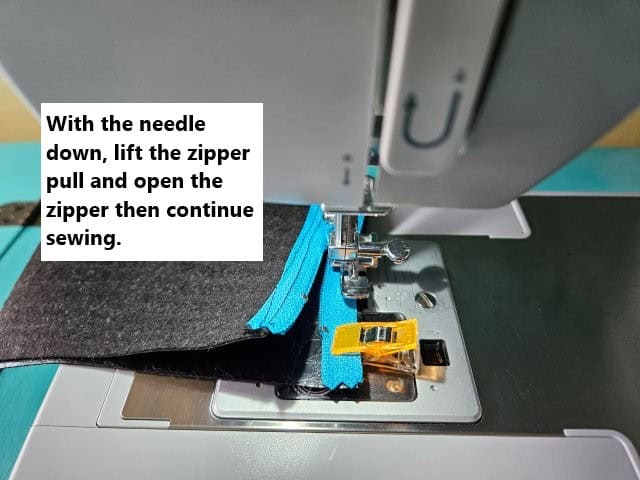 Lift zipper foot and open the zipper to continue sewing