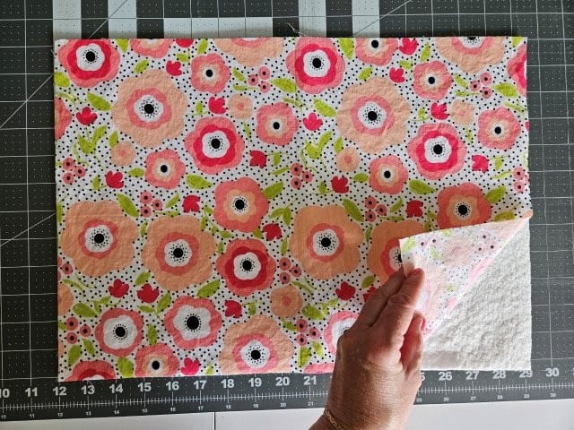 Place batting underneath one of the outer fabric pieces