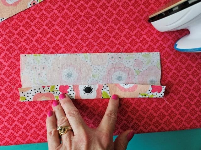 Open up the strap and fold to the center