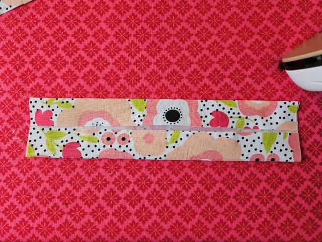 Turn the strap around and fold the other side to center