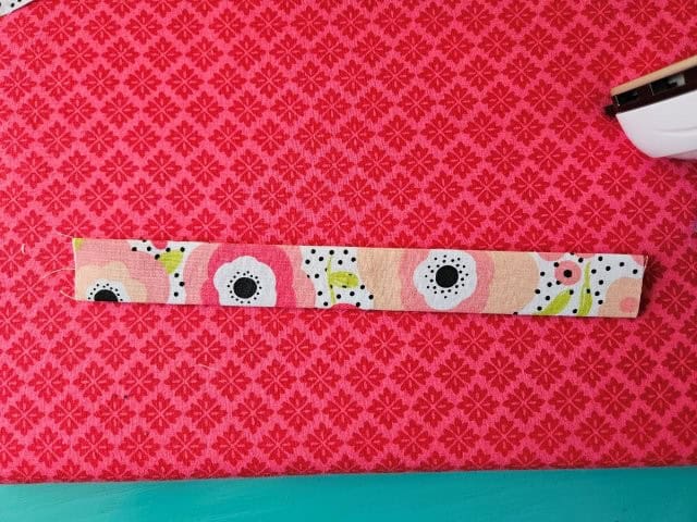 Fold the strap in half again and press