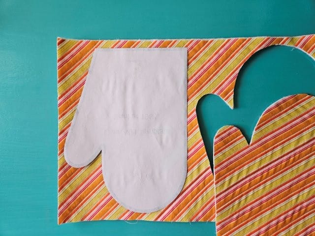 Turn over oven mitt template and place on left side of fabric