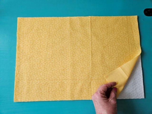 Place the lining fabric on top of the batting