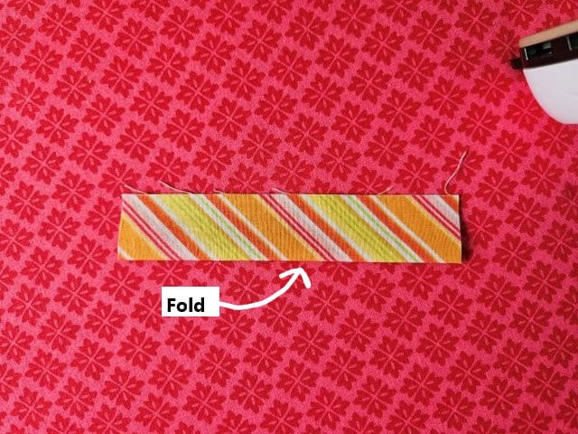 Fold loop fabric in half lengthwise