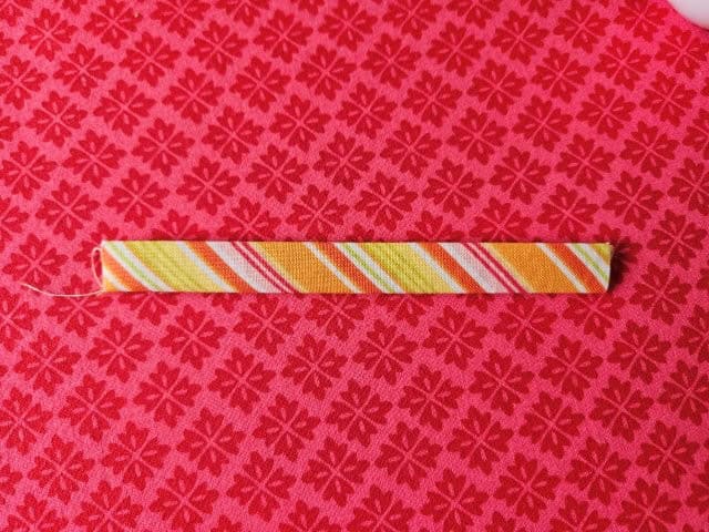 Fold the loop strap in half again and press