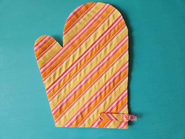 Fold the strap loop and clip to outer mitt