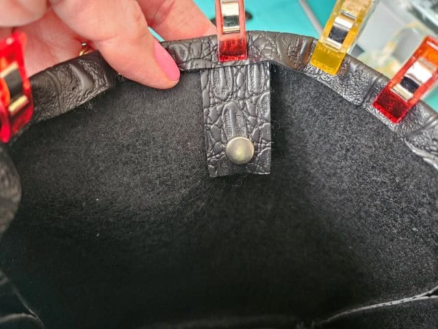 Slip the snap strap under the fold and clip to hold