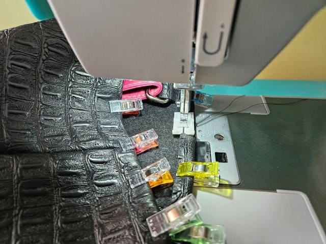 Top stitch around the top of the faux leather crossbody bag