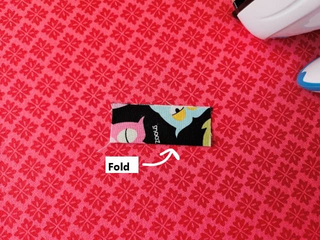 Fold the short strap in half lengthwise