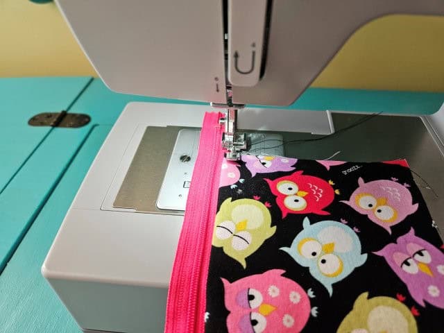 Top stitch along the zipper