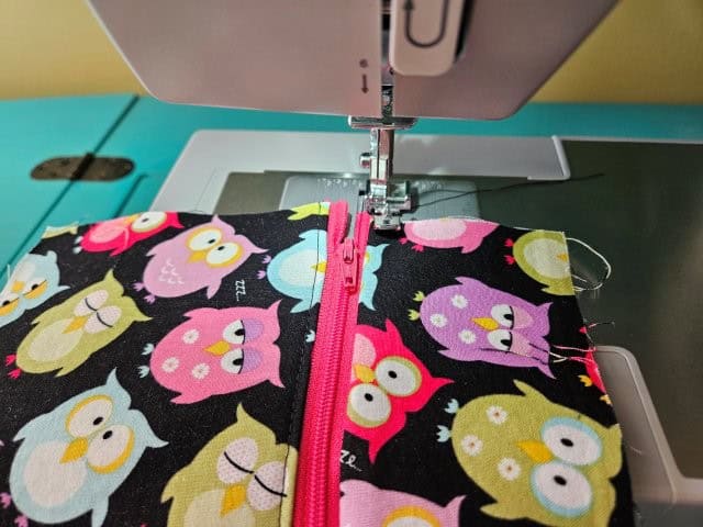 Top stitch along the zipper