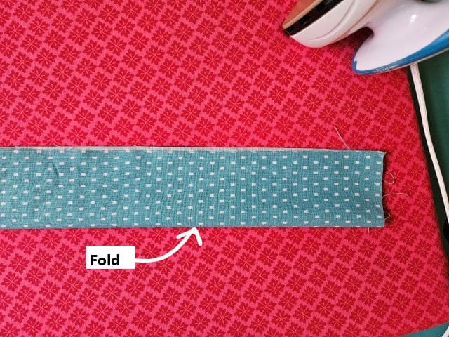 Fold the tote bag strap in half lengthwise