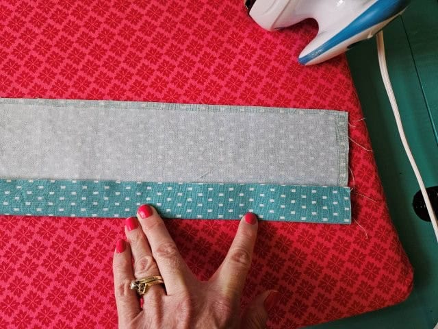 Open up the strap and fold to center