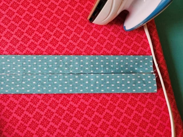 Turn the strap around and fold the other side to center