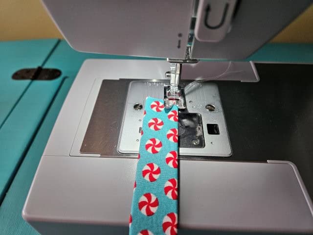 Sew each strap lengthwise along the folded edges