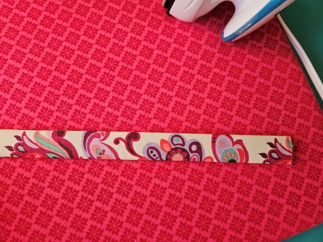 Fold the strap in half again