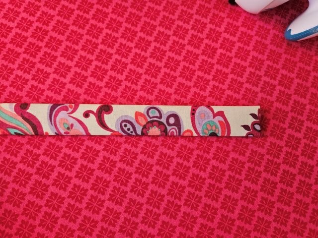 Fold the strap in half again