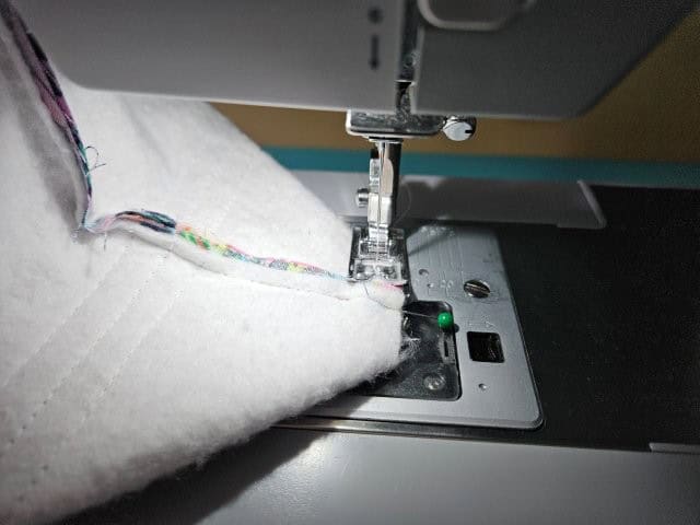Sew along the edge of the pinched square