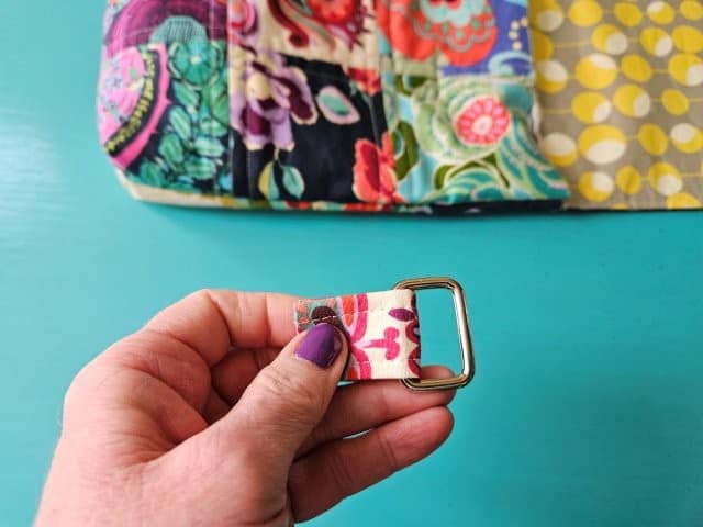 Place short strap through ring and fold over