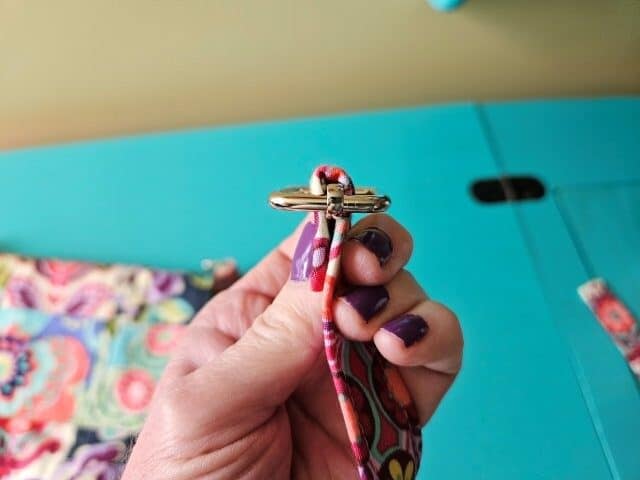 Place the strap through the slide and fold over