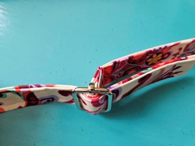 Continue the strap through the slide