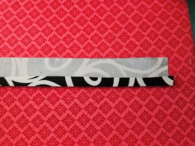 Fold one side of strap to center