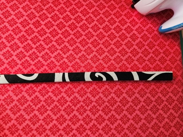 Fold the purse strap in half again and press